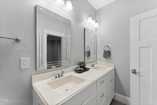 bathroom with a sink and double vanity