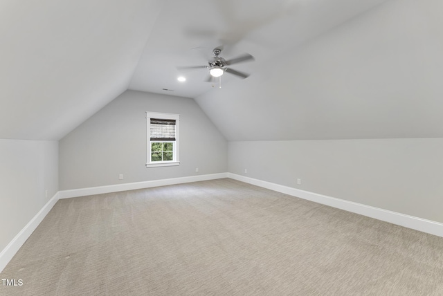 additional living space with carpet floors, baseboards, ceiling fan, and lofted ceiling