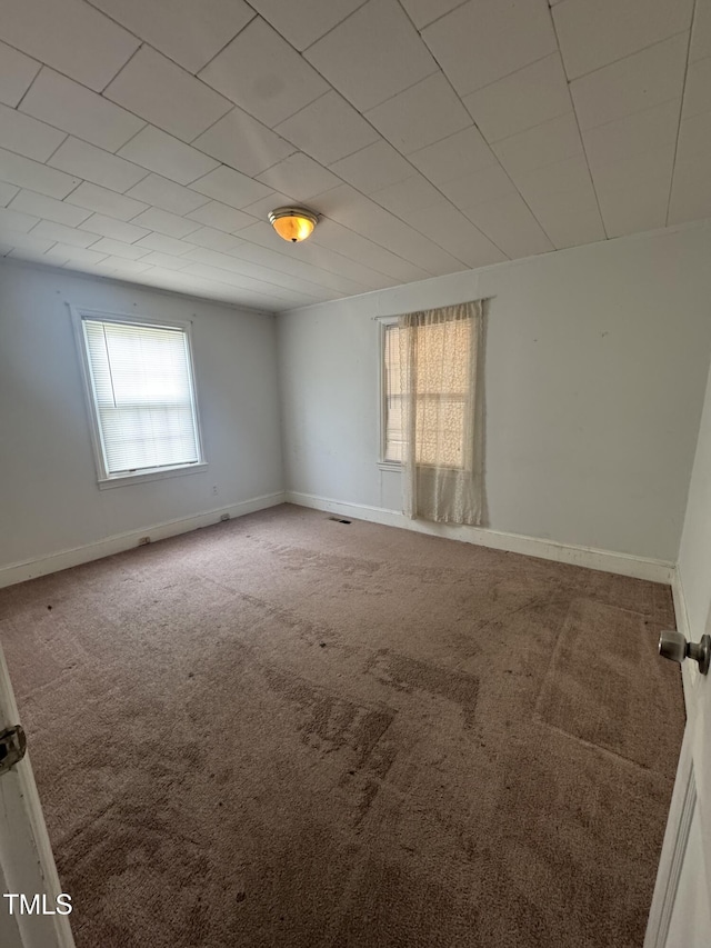 carpeted spare room with baseboards
