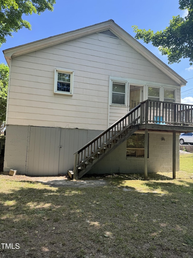rear view of property with a deck and stairway