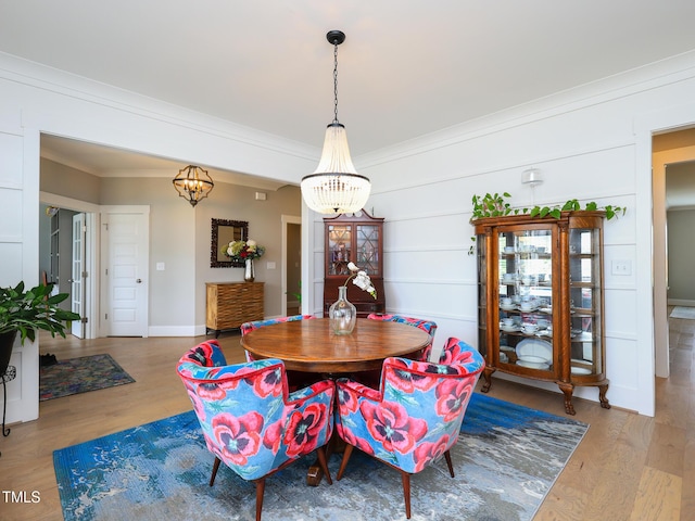 1180 Duke Farm Dr, Wake Forest, NC 27587 - dining area with a chandelier, ornamental molding, and wood finished floors