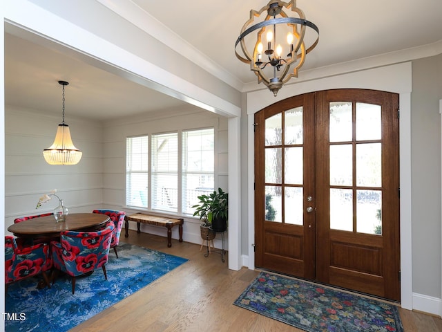 1180 Duke Farm Dr, Wake Forest, NC 27587 - entrance foyer featuring a chandelier, french doors, wood finished floors, ornamental molding, and baseboards