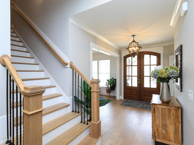 1180 Duke Farm Dr, Wake Forest, NC 27587 - foyer entrance with a chandelier, wood finished floors, stairs, baseboards, and ornamental molding