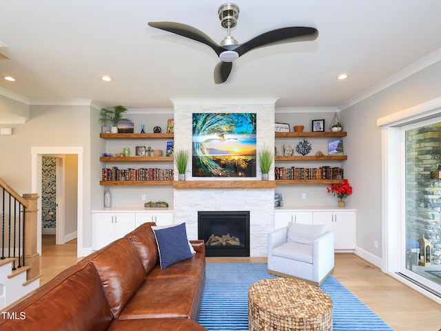 1180 Duke Farm Dr, Wake Forest, NC 27587 - living area with light wood finished floors, a large fireplace, stairs, ornamental molding, and ceiling fan