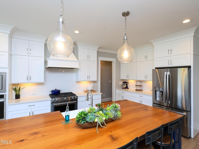 1180 Duke Farm Dr, Wake Forest, NC 27587 - kitchen featuring stainless steel appliances, pendant lighting, white cabinetry, recessed lighting, and tasteful backsplash