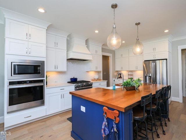 1180 Duke Farm Dr, Wake Forest, NC 27587 - kitchen featuring stainless steel appliances, custom exhaust hood, wood counters, white cabinetry, and backsplash