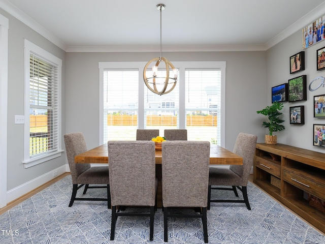 1180 Duke Farm Dr, Wake Forest, NC 27587 - dining space with healthy amount of natural light, ornamental molding, wood finished floors, a chandelier, and baseboards