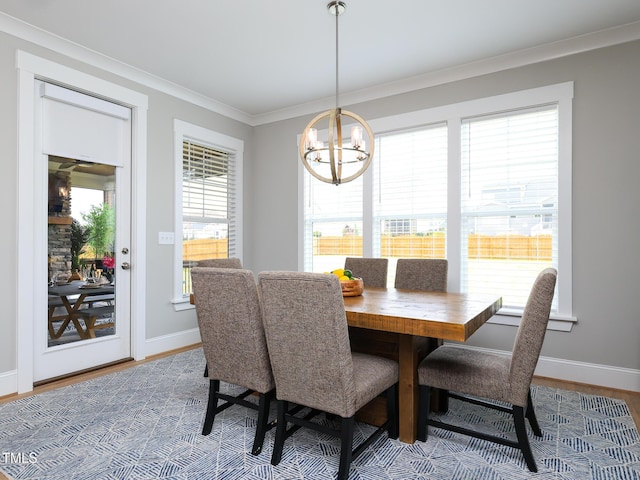 1180 Duke Farm Dr, Wake Forest, NC 27587 - dining space featuring ornamental molding, wood finished floors, a chandelier, and baseboards