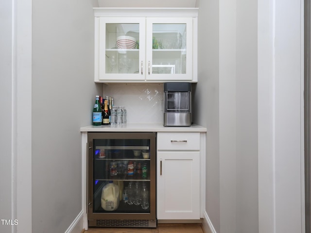1180 Duke Farm Dr, Wake Forest, NC 27587 - indoor dry bar featuring wine cooler, tasteful backsplash, and baseboards