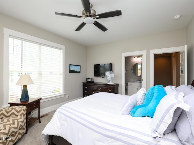 1180 Duke Farm Dr, Wake Forest, NC 27587 - carpeted bedroom featuring baseboards, a ceiling fan, and connected bathroom