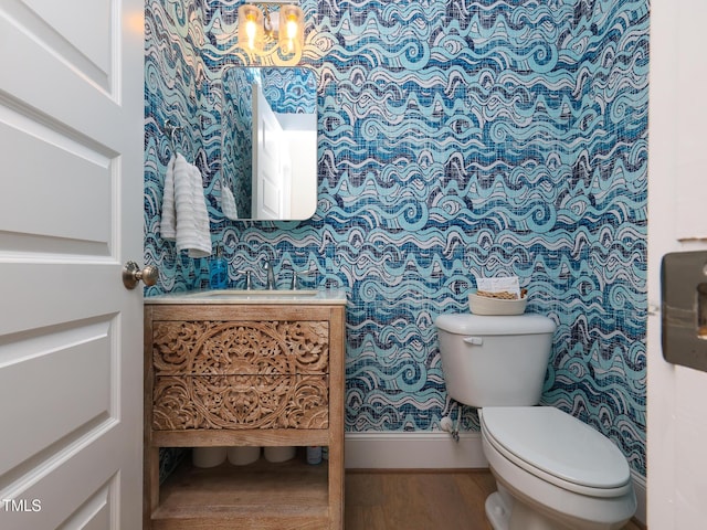 1180 Duke Farm Dr, Wake Forest, NC 27587 - half bathroom with wood finished floors, toilet, a chandelier, vanity, and baseboards