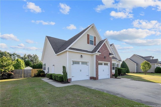 view of side of property with a shingled roof, a yard, fence, and driveway