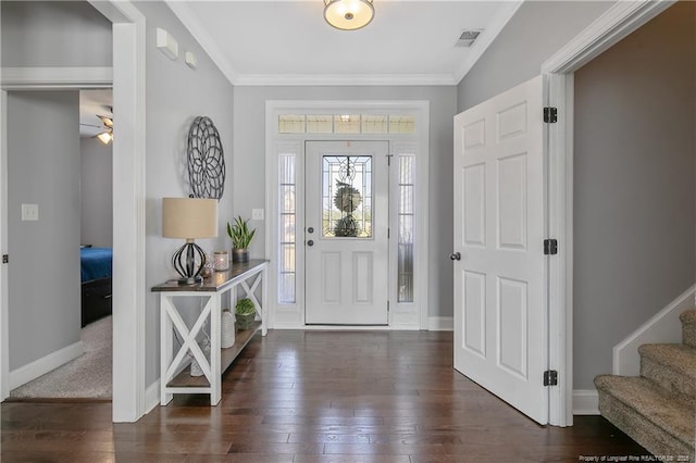 entrance foyer with crown molding, baseboards, visible vents, and hardwood / wood-style flooring