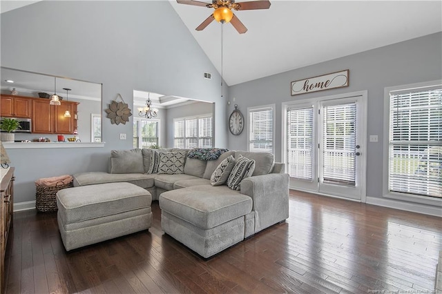 living room with high vaulted ceiling, ceiling fan with notable chandelier, baseboards, visible vents, and dark wood-style floors