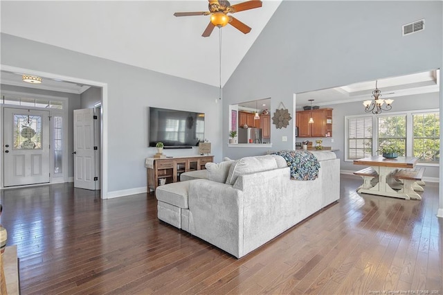 living room featuring ceiling fan with notable chandelier, baseboards, visible vents, ornamental molding, and hardwood / wood-style flooring