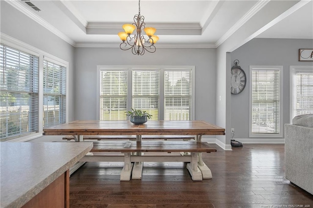 dining room featuring a chandelier, dark wood finished floors, a raised ceiling, and visible vents