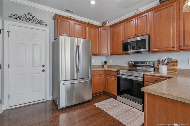 kitchen with ornamental molding, stainless steel appliances, brown cabinets, and visible vents