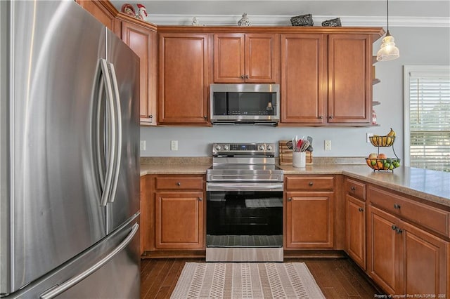 kitchen with crown molding, light countertops, brown cabinets, and stainless steel appliances