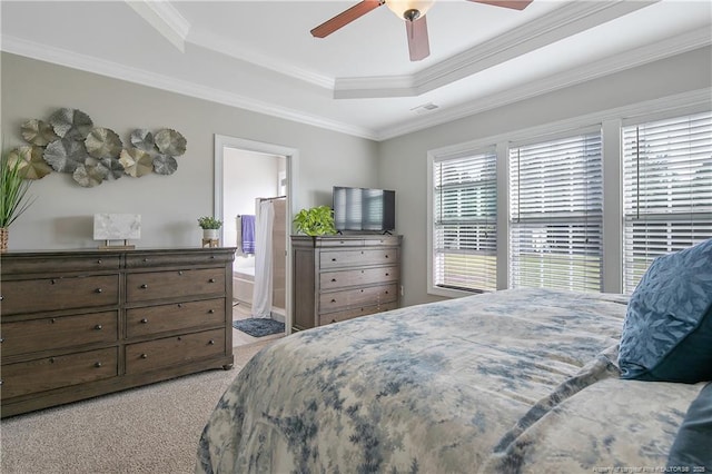 bedroom featuring a raised ceiling, ornamental molding, light colored carpet, and visible vents