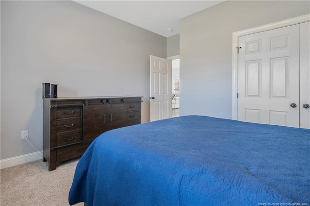 bedroom featuring baseboards and carpet