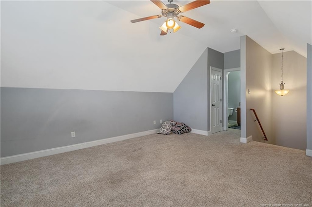 additional living space featuring a ceiling fan, baseboards, vaulted ceiling, and carpet