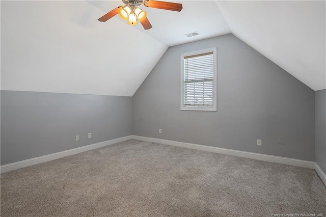 bonus room with carpet floors, visible vents, baseboards, a ceiling fan, and vaulted ceiling