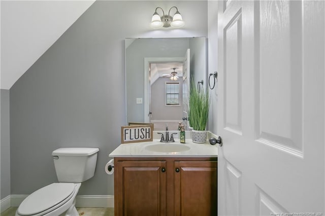 half bathroom with toilet, baseboards, and vanity