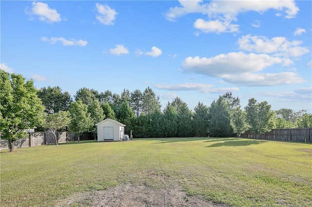 view of yard with a storage shed, fence, and an outdoor structure