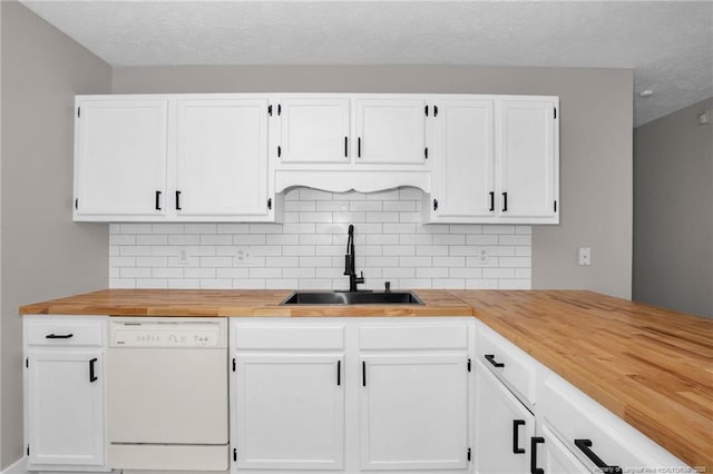 kitchen with white cabinets, white dishwasher, and a sink