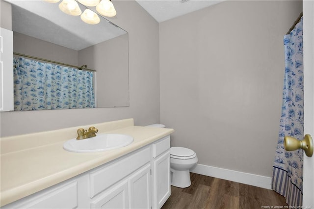 full bathroom with vanity, wood finished floors, curtained shower, toilet, and baseboards