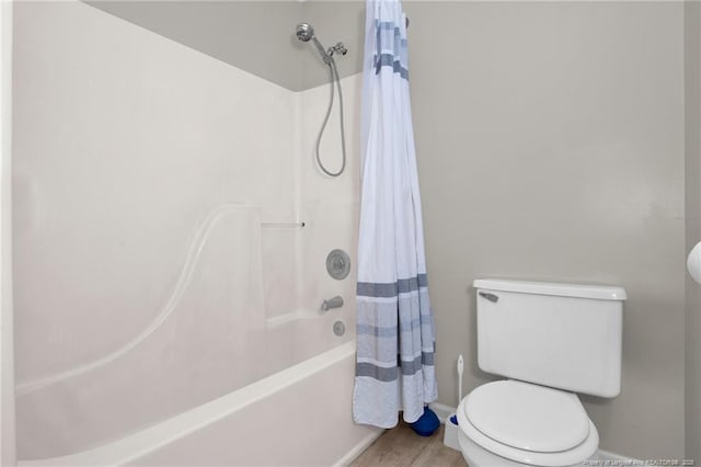 bathroom with shower / tub combo, wood finished floors, and toilet