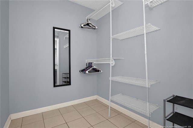 walk in closet with tile patterned floors