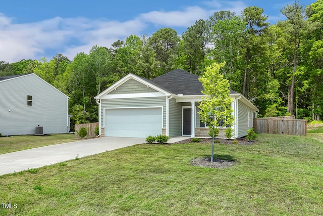 single story home featuring an attached garage, driveway, fence, and a front lawn
