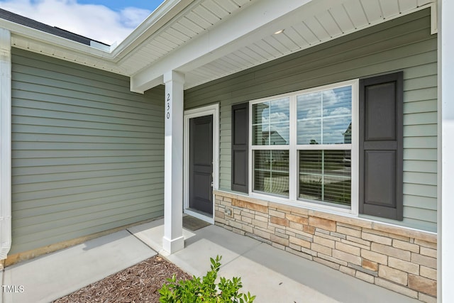 view of exterior entry featuring stone siding