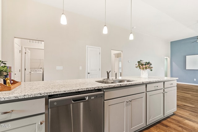 kitchen featuring light wood-style floors, pendant lighting, a sink, and dishwasher