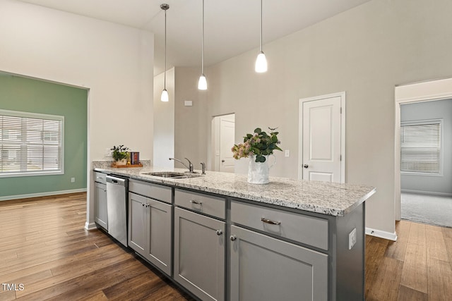 kitchen with dishwasher, a peninsula, a sink, and gray cabinets