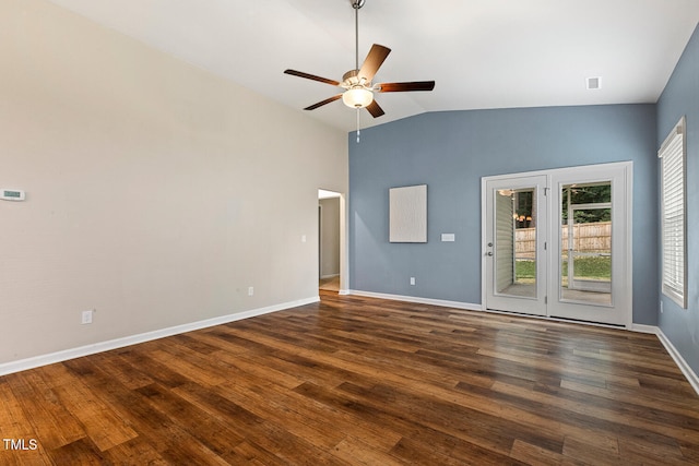 empty room featuring a ceiling fan, visible vents, baseboards, vaulted ceiling, and dark wood-style floors