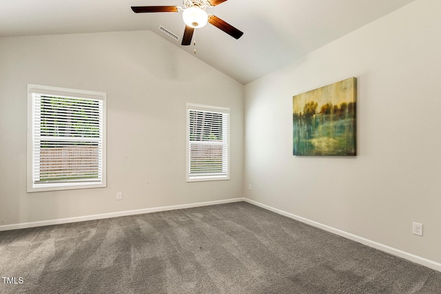 empty room featuring lofted ceiling, visible vents, carpet flooring, a ceiling fan, and baseboards