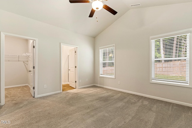 unfurnished bedroom with multiple windows, light carpet, and visible vents
