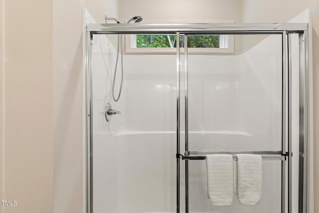 full bath with a shower stall