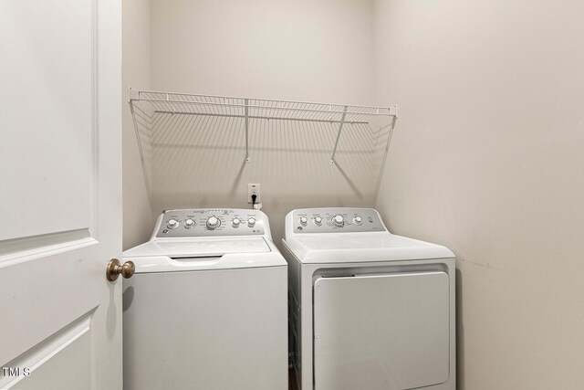 washroom with laundry area and washer and dryer