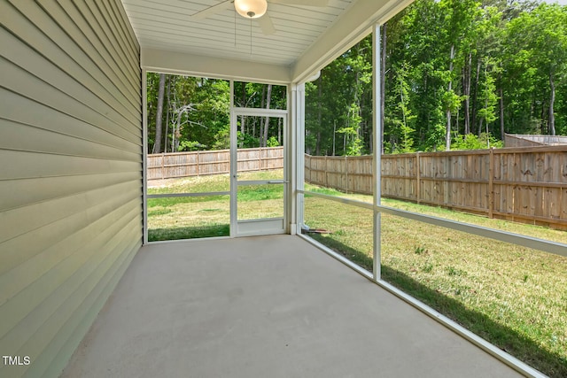 unfurnished sunroom with ceiling fan