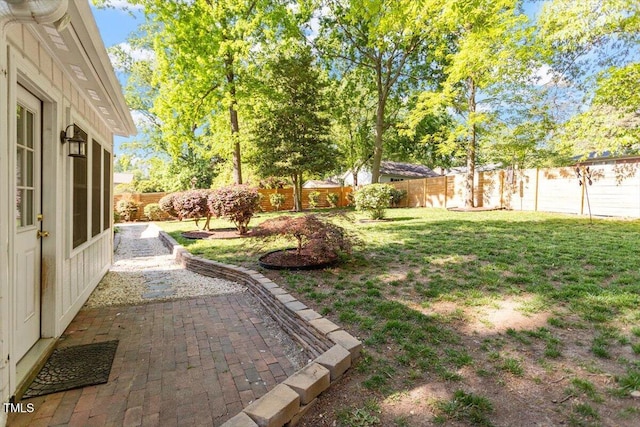 view of yard with a fenced backyard and a patio area