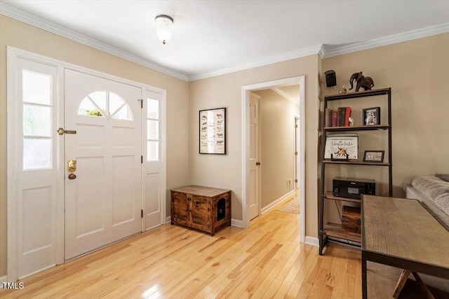 entryway with baseboards, ornamental molding, and light wood-style flooring