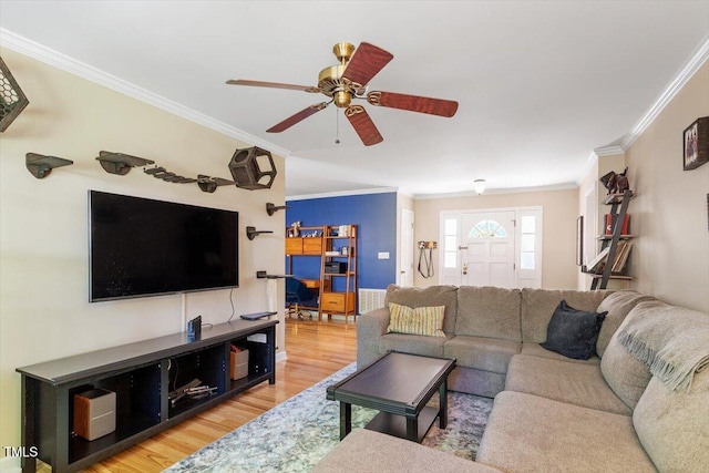 living area with light wood-type flooring, ornamental molding, and ceiling fan