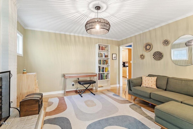 living room with crown molding, built in features, wood finished floors, and a wealth of natural light