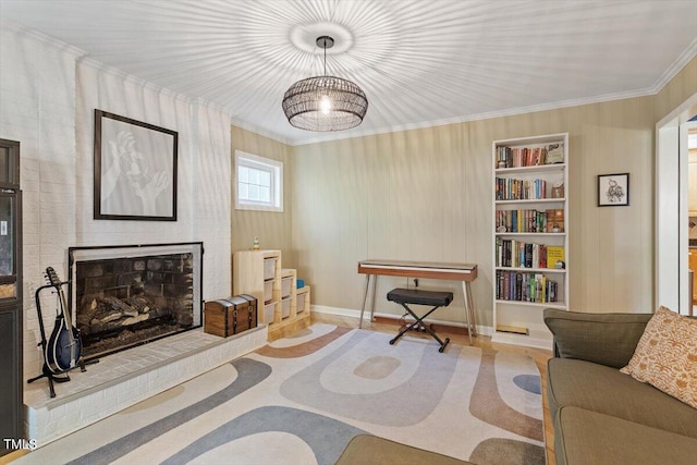 living room featuring baseboards, built in shelves, ornamental molding, and a fireplace