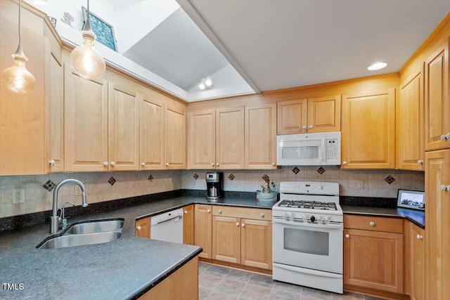 kitchen featuring white appliances, dark countertops, a sink, and light brown cabinets