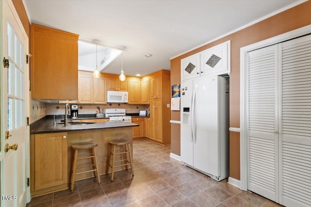 kitchen with decorative backsplash, a peninsula, white appliances, a sink, and decorative light fixtures