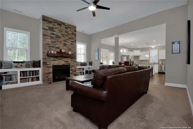 308 Wishaw Ct, Hope Mills, NC 28348 - living area featuring carpet floors, ceiling fan, baseboards, and a fireplace